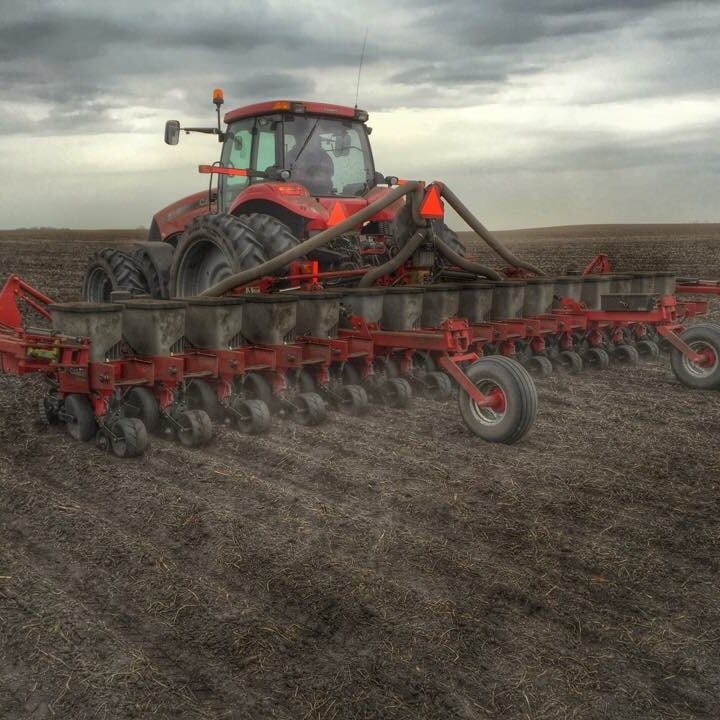 Red Case IH Planter in Field on a Cloudy Day