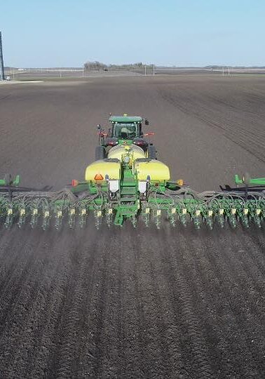 John Deere Tractor and Planter in Field